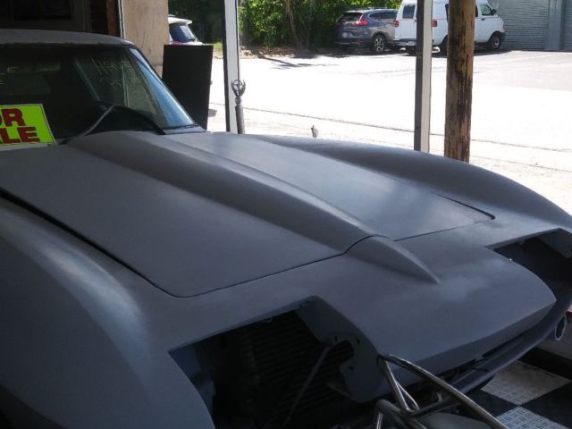1965 Corvette Coupe, 327 mtr. $38,000. In primer, 99% complete. 4 dps. Runs. 1965 Chevrolet Corvette Coupe