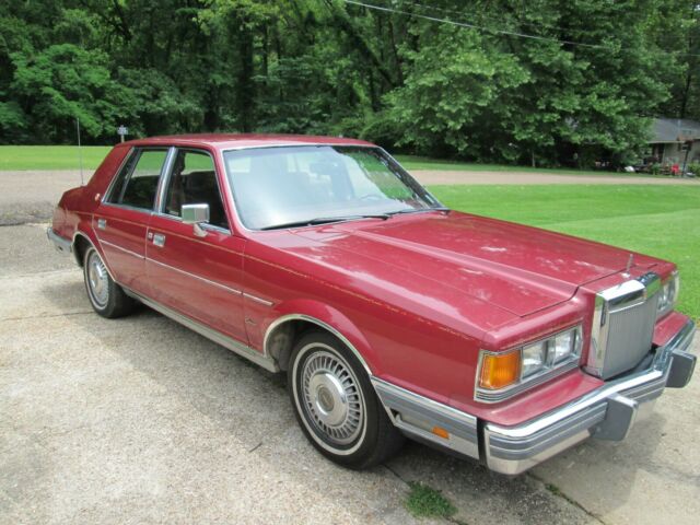 1983 Red Lincoln Continental 4-door sedan. 1983 Lincoln Continental Base