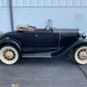 1931 Ford Model A roadster. Blue exterior, brown interior, tan top. Clean car!