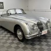 1959 JAGUAR XK150 SE ROADSTER. SILVER WITH GREY TRIM, BLACK TOP.