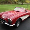 1960 Corvette.  Red/Red, white coves.  NOM 327 4-speed