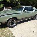 1972 Oldsmobile Cutlass with Hurst stripes.