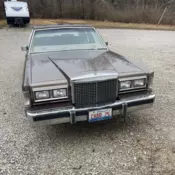 1985 4 door Lincoln town car in tan.