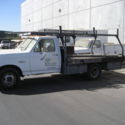 1987 Ford F-350 flatbed with rack. Dually wheels in back. Started with a jump.