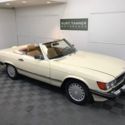 1988 MERCEDES BENZ 560 SL. LIGHT IVORY WITH PALOMINO TRIM. DARK BROWN SOFT TOP.