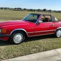 1989 Mercedes Benz 560 SL.  Red exterior and tan interior.