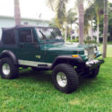 1990 Jeep Wrangler. Hunter green with black soft top.