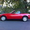 1990 Mazda Miata, red with a black cloth interior
