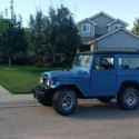 A 1971 Toyota Land Cruiser FJ40, Ford midnight blue with a black top.