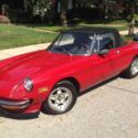 Alfa Romeo Spyder with 65,095 miles.  Red with black covertable top and interior