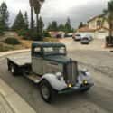 Classic 1935 GMC Dually Flat Bed Pickup sitting on a Hot Rod Chevy Dually