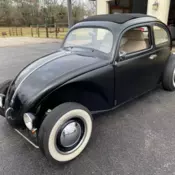 Rag top, oval window, open wheel.