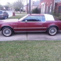 Red with white vinyl top. Sport Wheels beginning to rust. Have original hubcaps