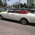 White convertible with burgundy leather interior; excellent condition