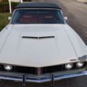 White Torino GT with black convertible top with red interior
